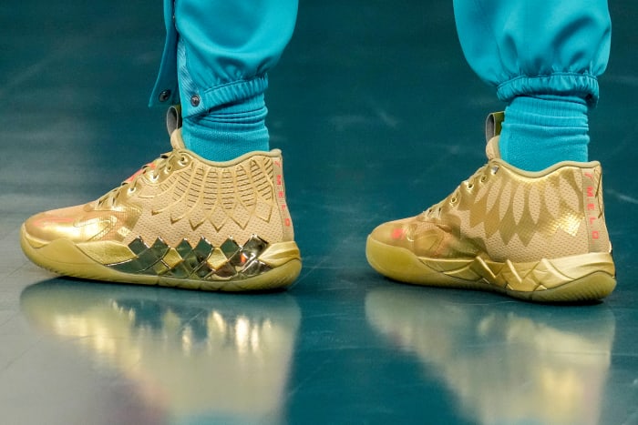 Charlotte Hornets guard LaMelo Ball's gold PUMA sneakers.